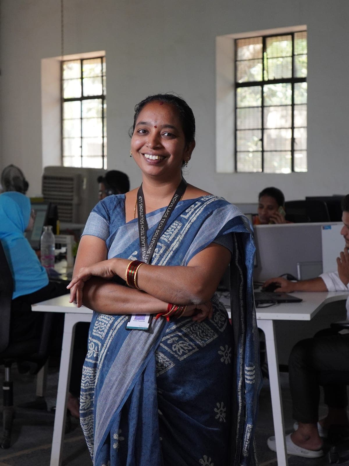 IndiVillage specialist in the operating centre — front of house, team working behind