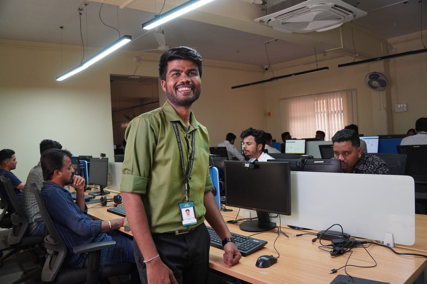 Operating centre in rural India showing workspace with multiple annotators at desks